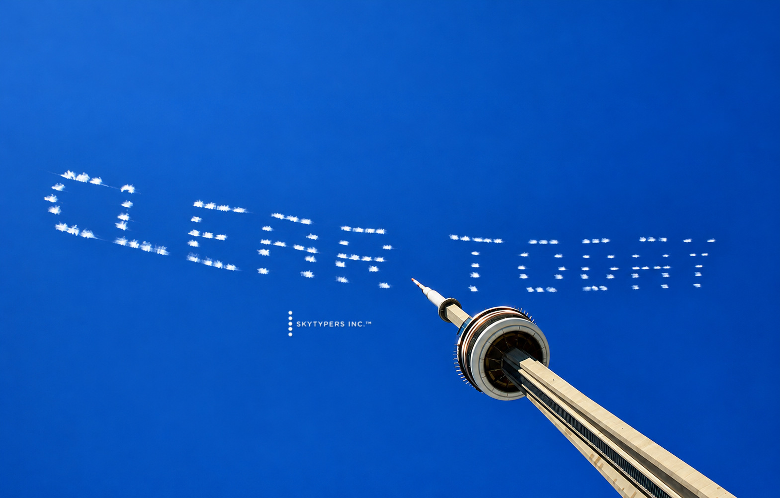 CLEAR TODAY written in white skytyping above Toronto’s CN Tower
