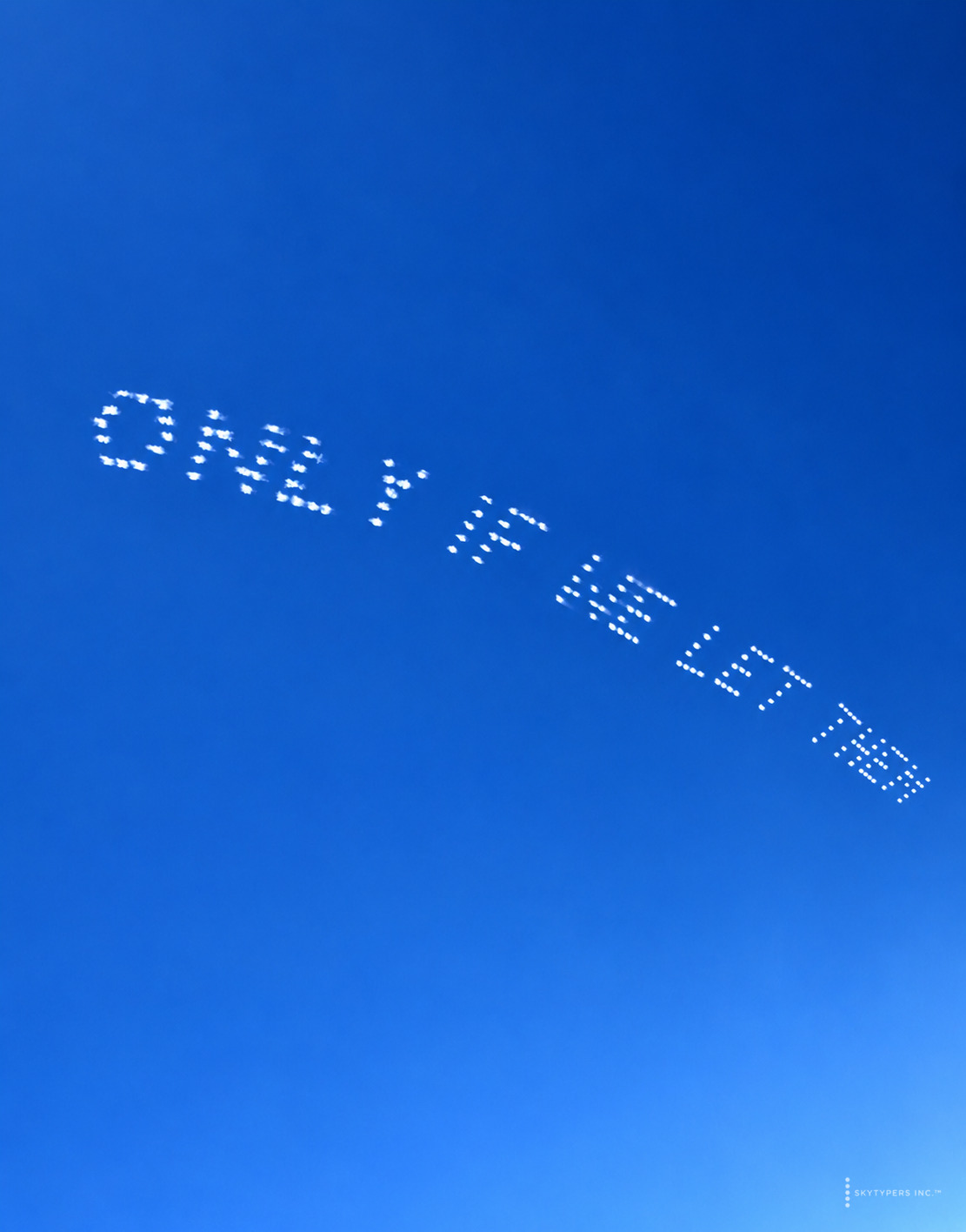 ONLY IF WE LET THEM written in dotted white smoke across a blue sky.