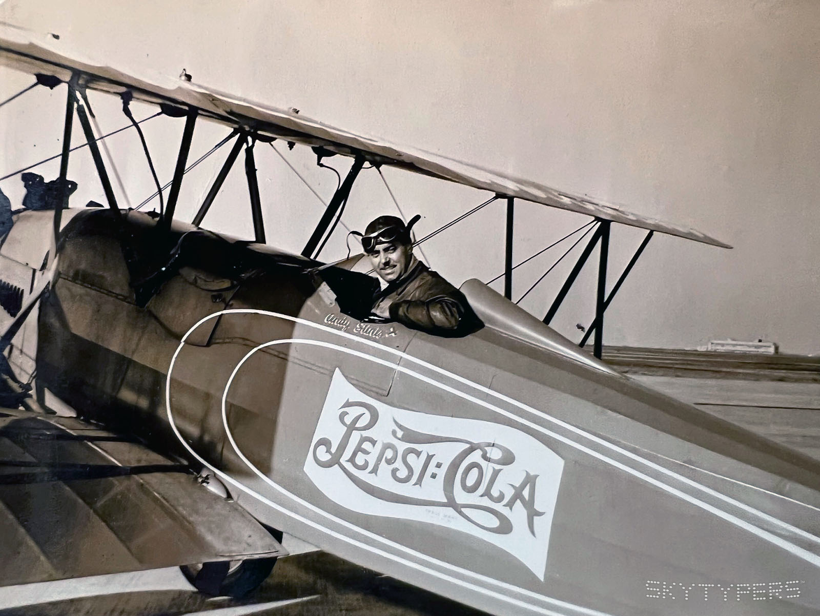 Pilot with a Pepsi-Cola biplane.