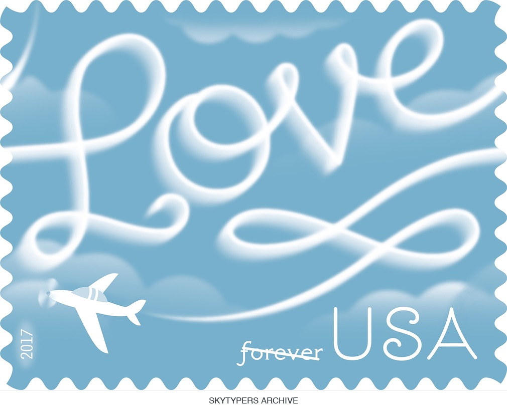 2017 USA Forever Love stamp with white skywriting script, an illustrated airplane and a blue sky design.
