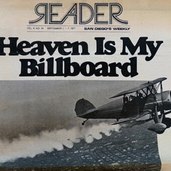 Black and white cover of San Diego's Reader: airplane flying over the city with headline "Heaven Is My Billboard.